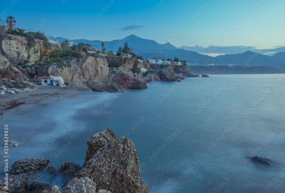 Nerja, Malaga, Andalusi, Spain - November 17, 2018: Panoramic view of the coast of the village of Nerja in a sunrise, long exposure