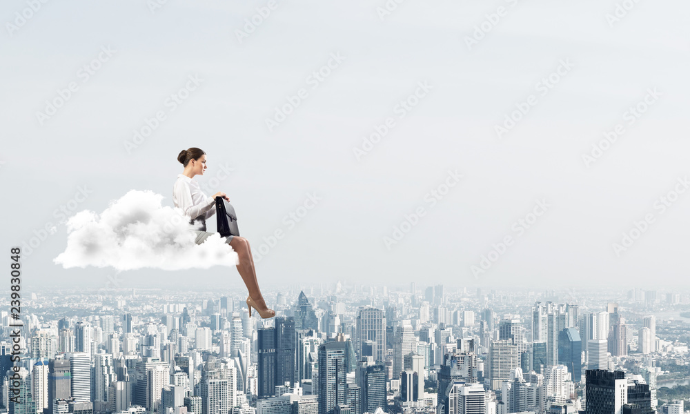 Businesswoman or accountant on cloud floating high above modern city Businesswoman or accountant on cloud floating high above modern city