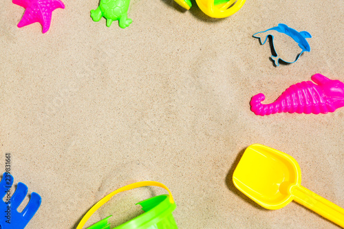 childhood and summer concept - close up of sand toys kit on beach