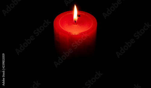 Red candle in the darkness