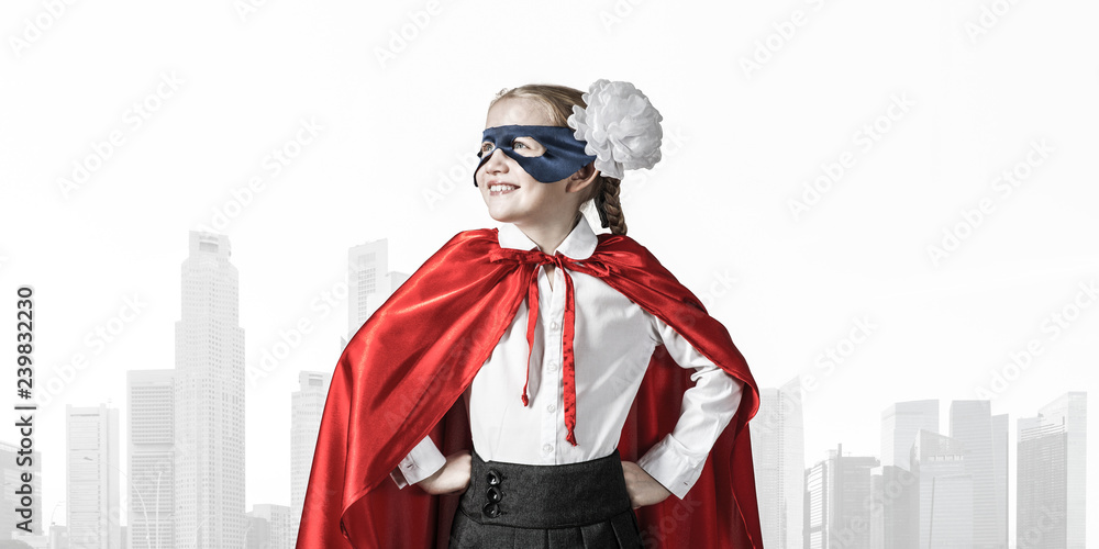 Obraz premium Girl power concept with cute kid guardian against cityscape back