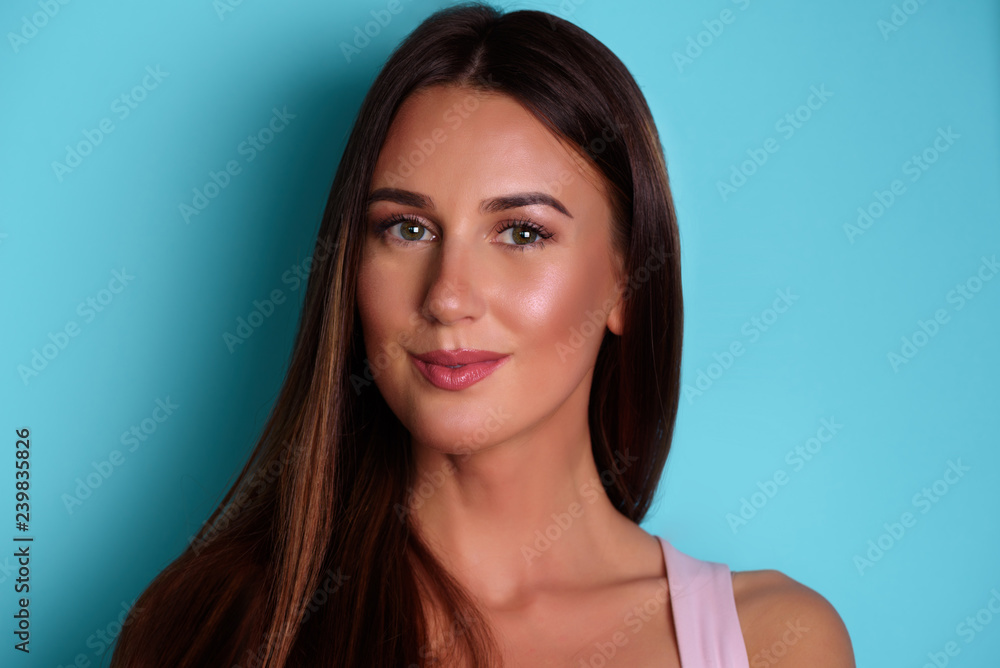 Happy cute young lady over blue background. Looking camera pointing. Skin care, pure beauty, body treatment, cosmetics concept. Banner with copy space Happy cute young lady over blue background. Looking camera pointing. Skin care, pure beauty, body treatment, cosmetics concept. Banner with copy space
