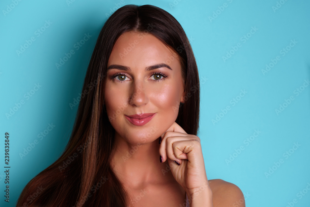 Happy cute young lady over blue background. Looking camera pointing. Skin care, pure beauty, body treatment, cosmetics concept. Banner with copy space Happy cute young lady over blue background. Looking camera pointing. Skin care, pure beauty, body treatment, cosmetics concept. Banner with copy space
