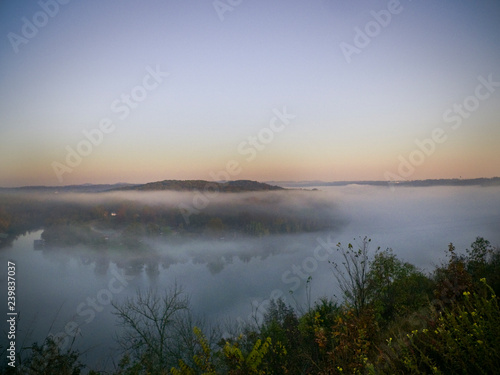 Mountain with fog and lake photo