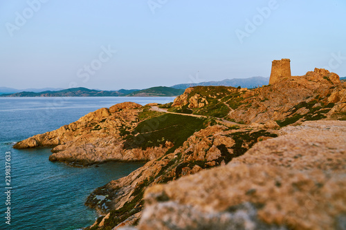 Golden rocks in Ille Rouse near lighthouse Pietra during sunset in Corsica