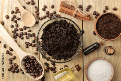 homemade coffee scrub in the face and body bowl and various ingredients for making scrub on a wooden table. spa. cosmetics. care cosmetics. view from above