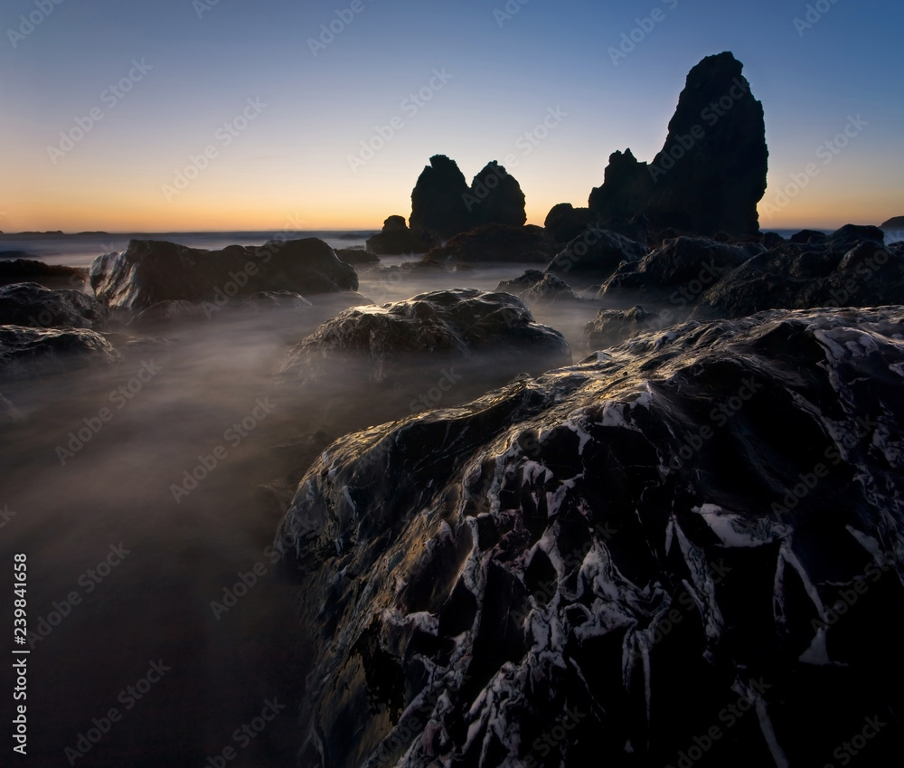 Giant sea stacks and rocky coastline at sunset, at Rodeo Beach, Marin Headlands, California