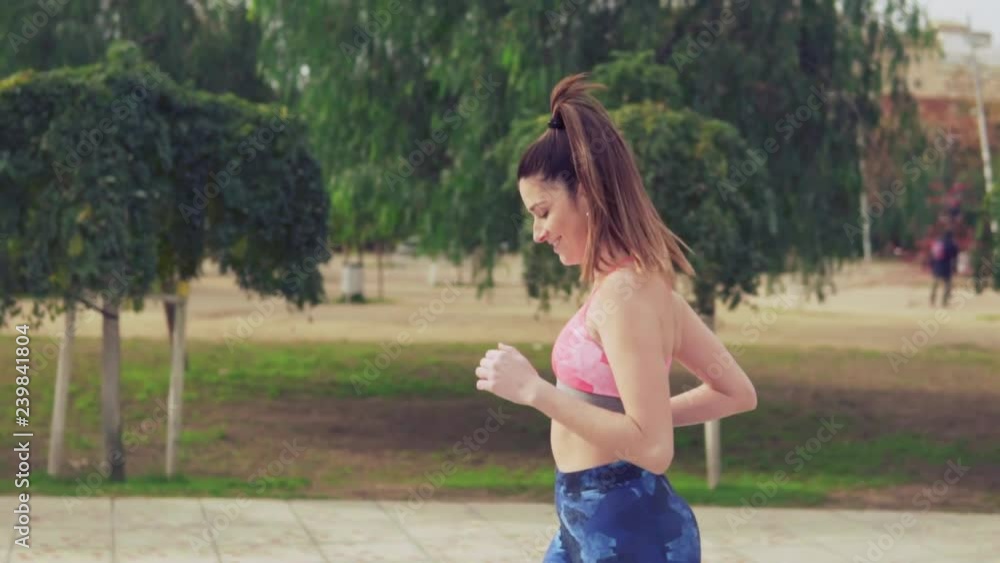 Slowmotion video of fit woman running in the park . morning sport training Slowmotion video of fit woman running in the park . morning sport training