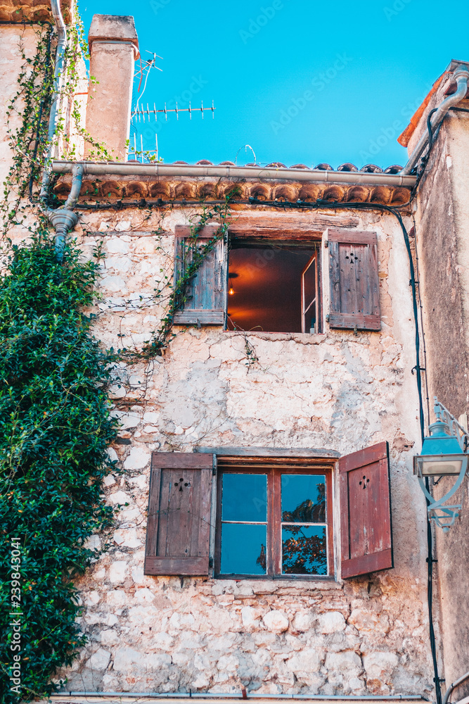 Old stone building with wooden shutters - Mediterranean architecture