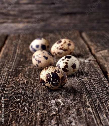 Quail eggs on the old background. Rustic style on dark wood background. photo