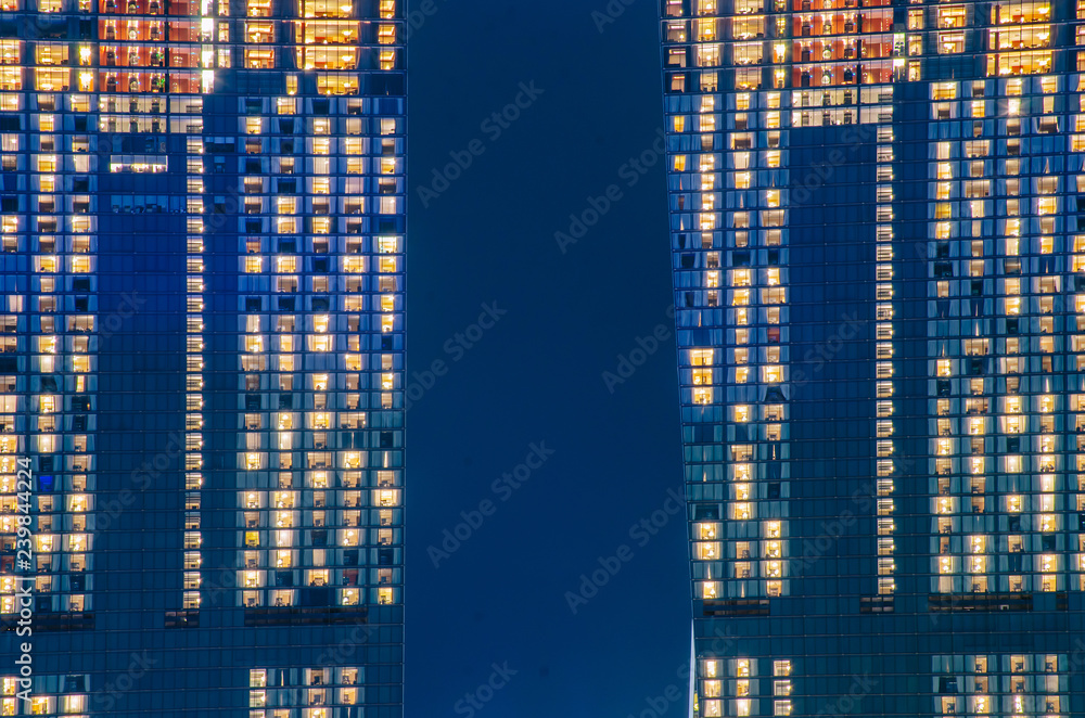 Obraz premium Close - up of a highly-detailed night windows pattern of modern metropolis.