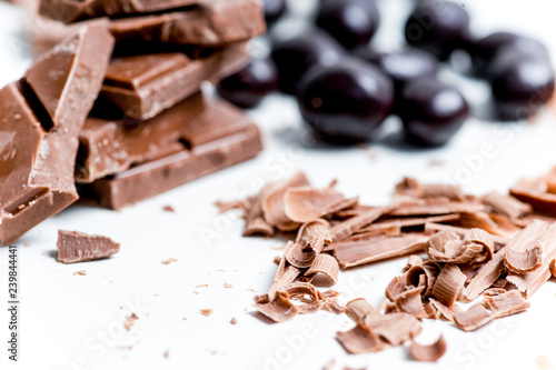 chocolate bar, shavings and cookies on a table