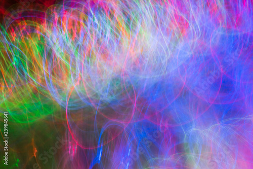 Defocused colored luminous spots and curved lines. For background