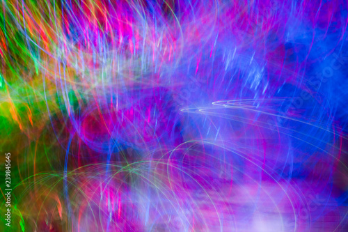 Defocused colored luminous spots and curved lines. For background