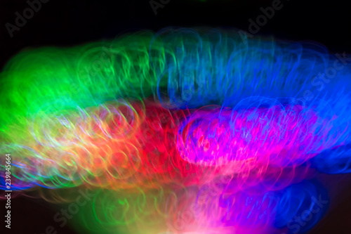 Defocused colored luminous spots and curved lines. For background