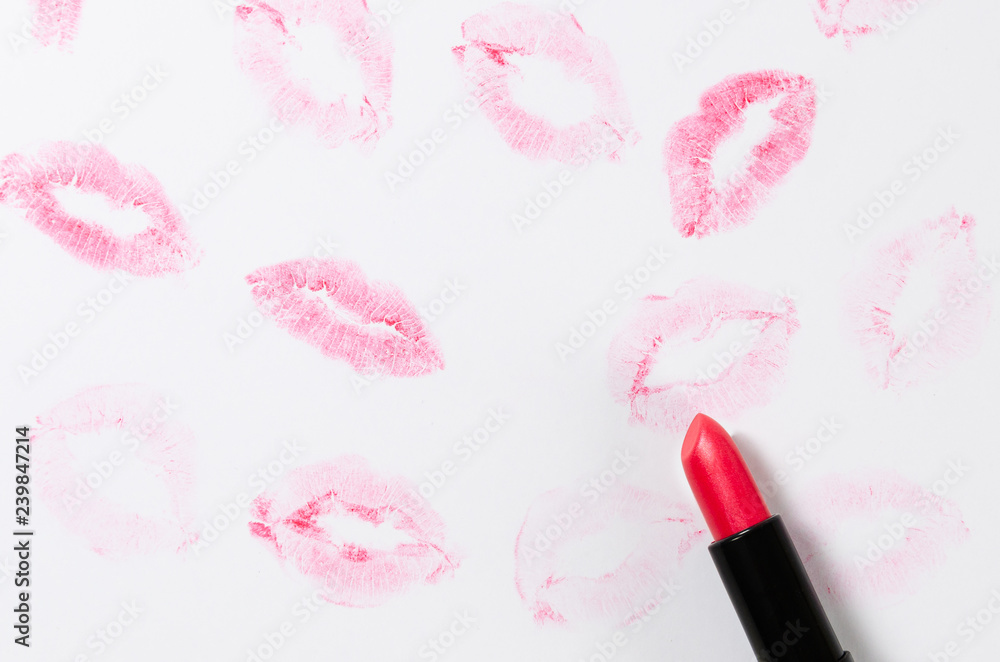 Obraz premium Lipstick kisses and lipstick tube on white background. St. Valentin's day concept. Copy space