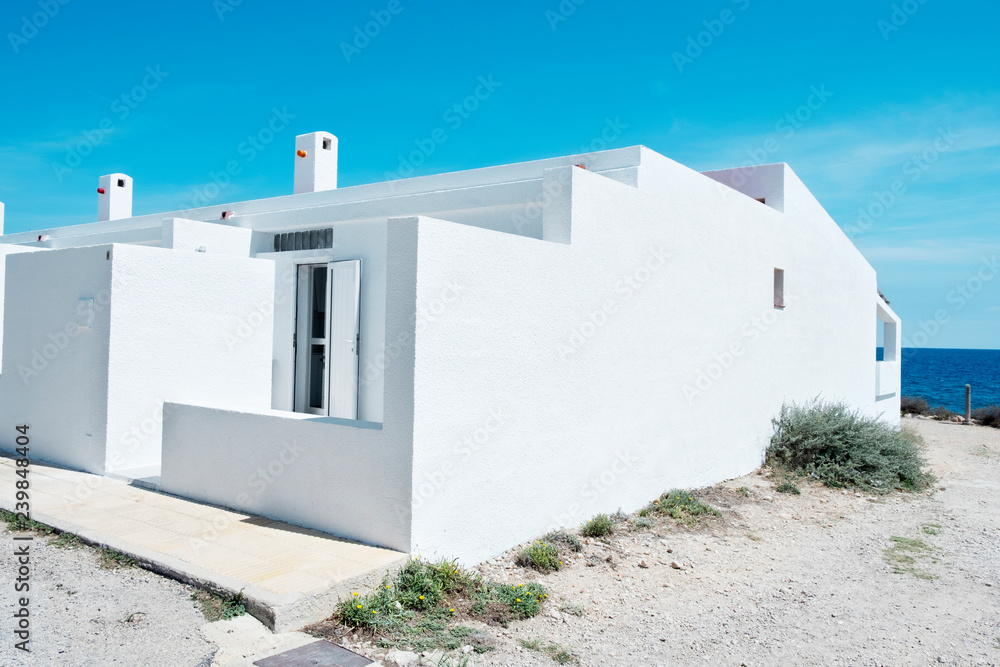 whitewashed houses next to the Mediterranean sea