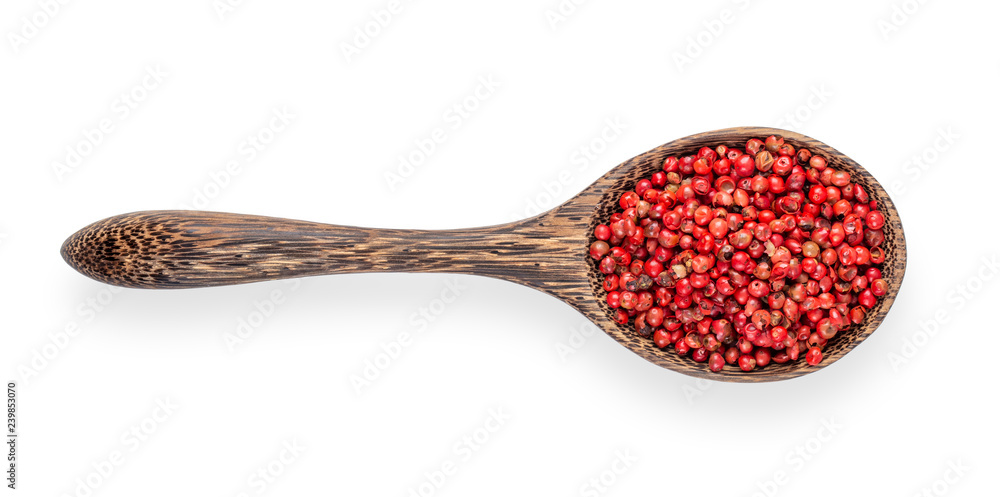 pink peppercorn in wood spoon isolated on white background. top view pink peppercorn in wood spoon isolated on white background. top view