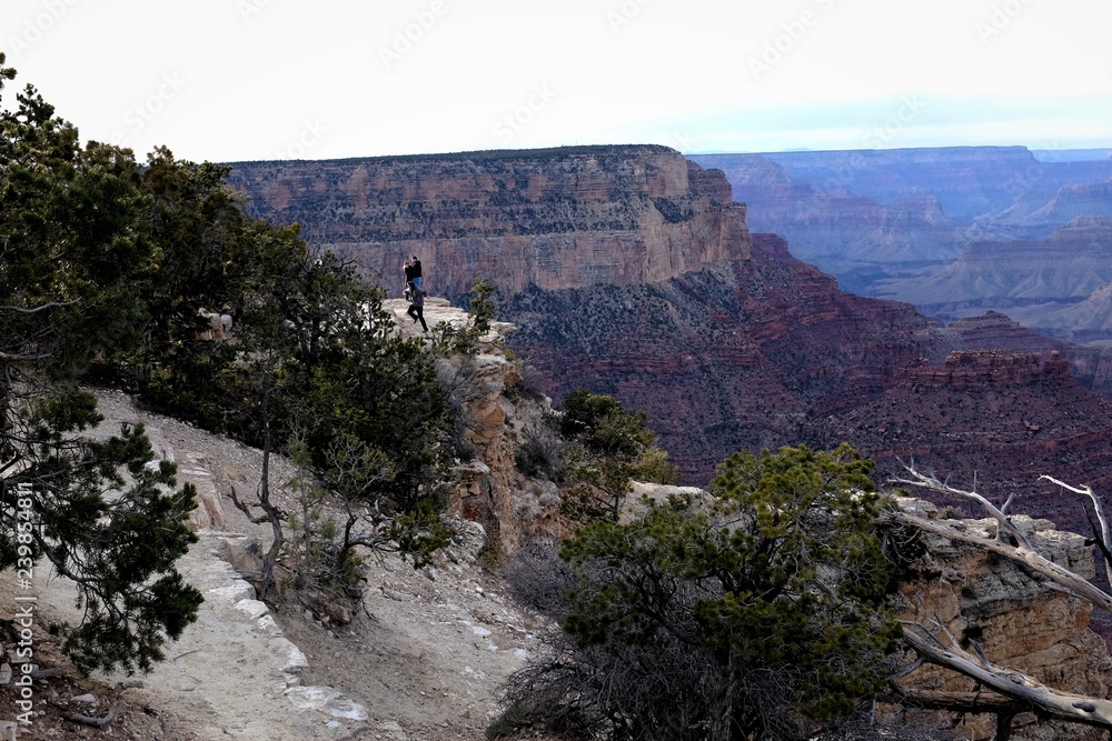 Little specks in the distance are people standing of the edge of a cliff at the Grand Canyon