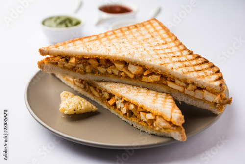 Paneer tikka Sandwich - is a popular Indian version of sandwich using cottage cheese curry with tomato ketchup, mint chutney photo