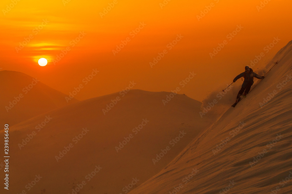 SILHOUETTE: Spectacular shot of pro skier riding off trail on a sunny evening. SILHOUETTE: Spectacular shot of pro skier riding off trail on a sunny evening.