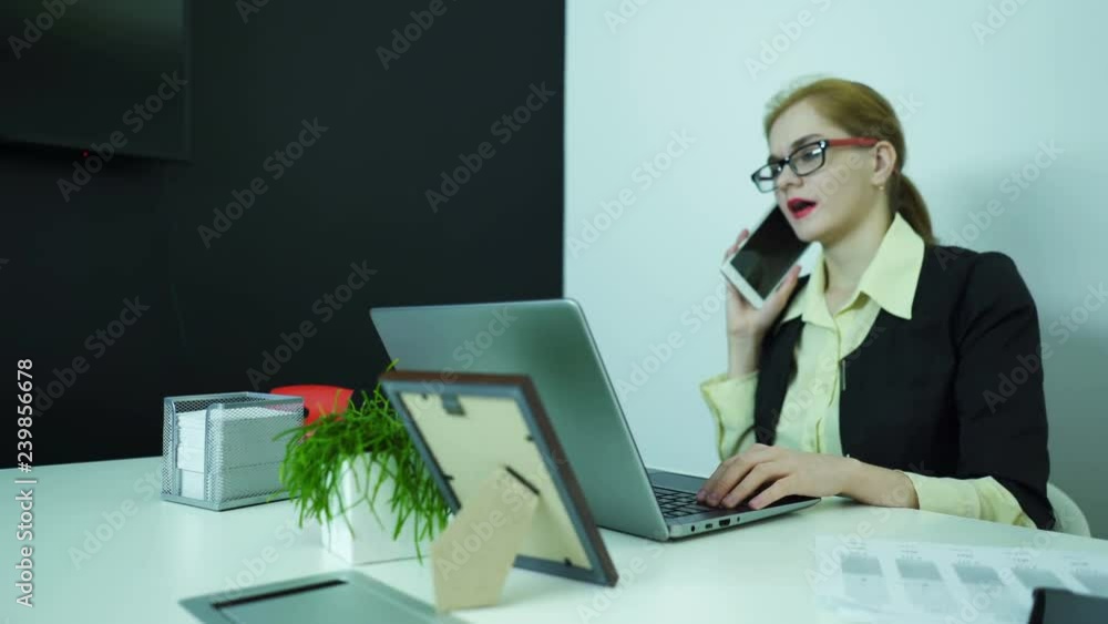 4К. Business woman answer smartphone call in office. Dolly shot 4К. Business woman answer smartphone call in office. Dolly shot