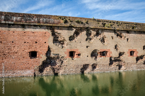 Bullet holes / cannon holes in the brick walls of Fort Pulaski National Monument in Georgia from the Civil War photo