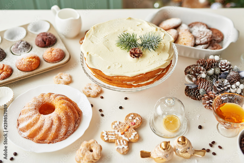 Christmas cake and sweets on table. Christmas decorations with lights background. Happy New Year! Christmas greeting card. Winter card template. Xmas concept. Holiday Banner. Feast of Nativity. Christmas cake and sweets on table. Christmas decorations with lights background. Happy New Year! Christmas greeting card. Winter card template. Xmas concept. Holiday Banner. Feast of Nativity.