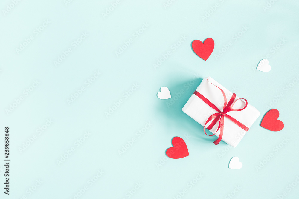 Valentine's Day background. Gift box on pastel blue background. Valentines day concept. Flat lay, top view, copy space