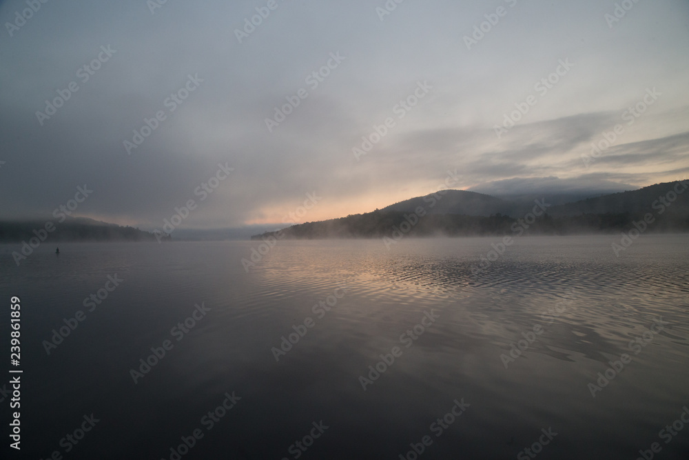 sunset over sea with fog