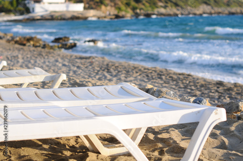 Furniture for outdoor area. Palm trees. Beach. Sea. Summer. The sun