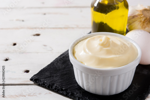 Photos Aioli sauce and ingredients on white wooden table