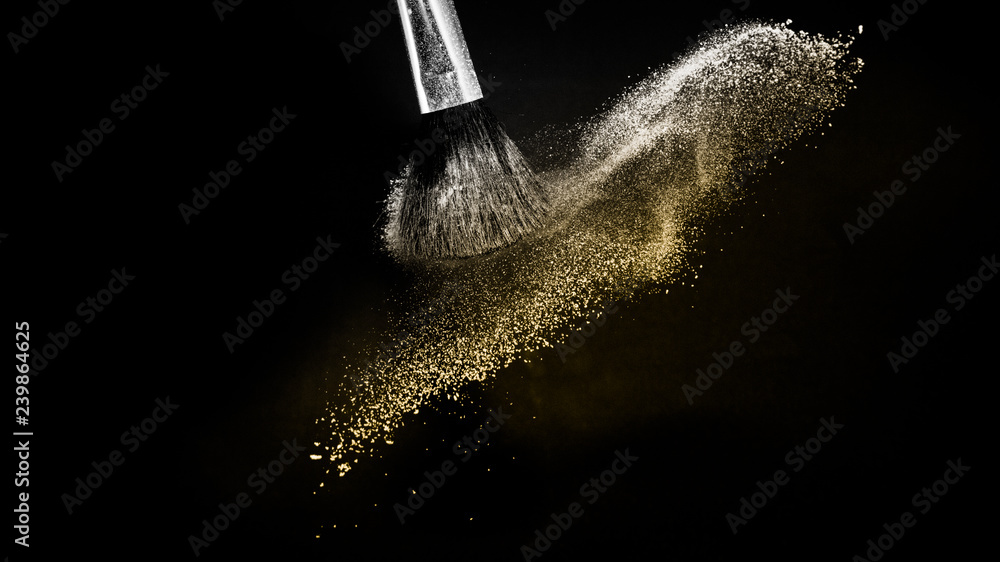 Obraz premium Cosmetic brush with golden cosmetic powder spreading for makeup artist or beauty blogger in black background, look like a luxury