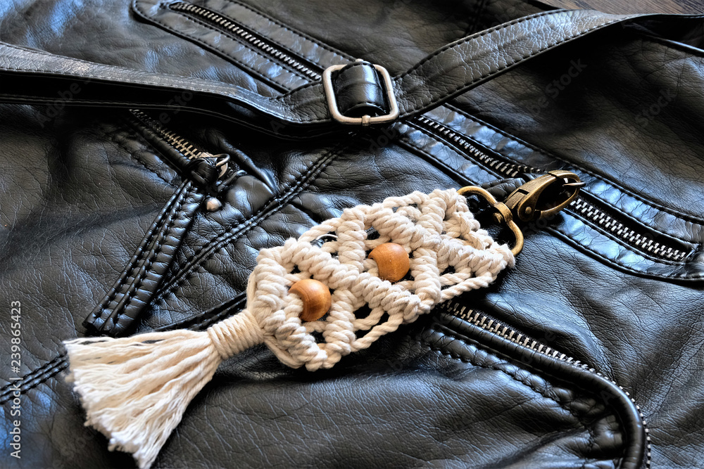 or purse / handbag clasp close up. The background is a beautiful black leather handbag.