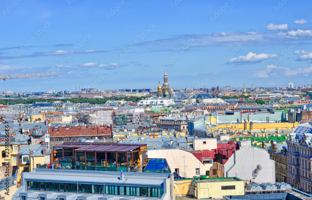Panorama of the city. The multi-colored roofs of buildings, the domes of the cathedral, the showcase of a glass cafe.