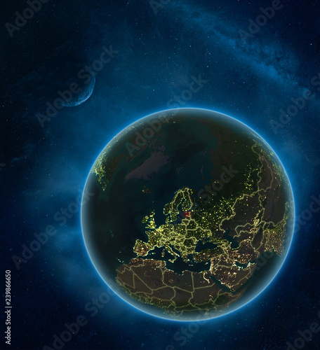 Fototapeta Naklejka Na Ścianę i Meble -  Estonia at night from space with Moon and Milky Way. Detailed planet Earth with city lights and visible country borders.