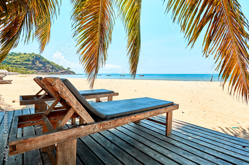Fototapeta Naklejka Na Ścianę i Meble -  beach lounger under coconut trees
