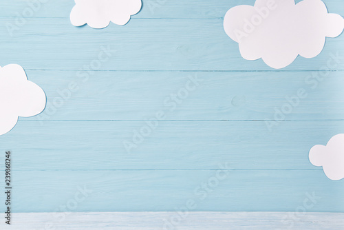 Cute children or baby background, white clouds on the blue wooden background photo