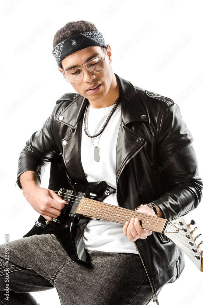 concentrated male rock musician in leather jacket playing on electric guitar while sitting on chair isolated on white concentrated male rock musician in leather jacket playing on electric guitar while sitting on chair isolated on white