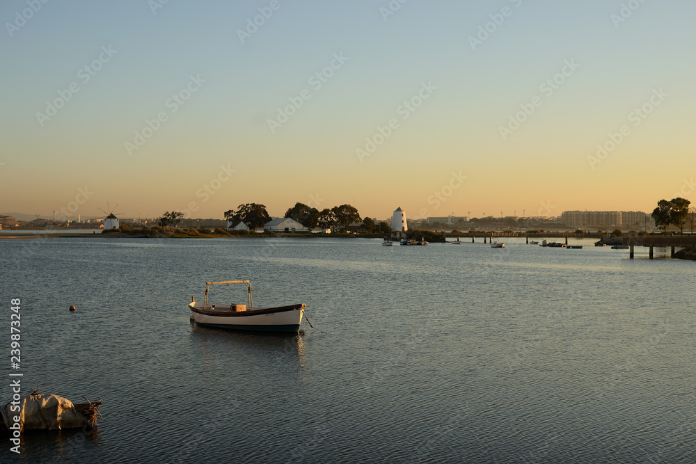 sunset overlooking the bay and boats, barreiro, lisbon