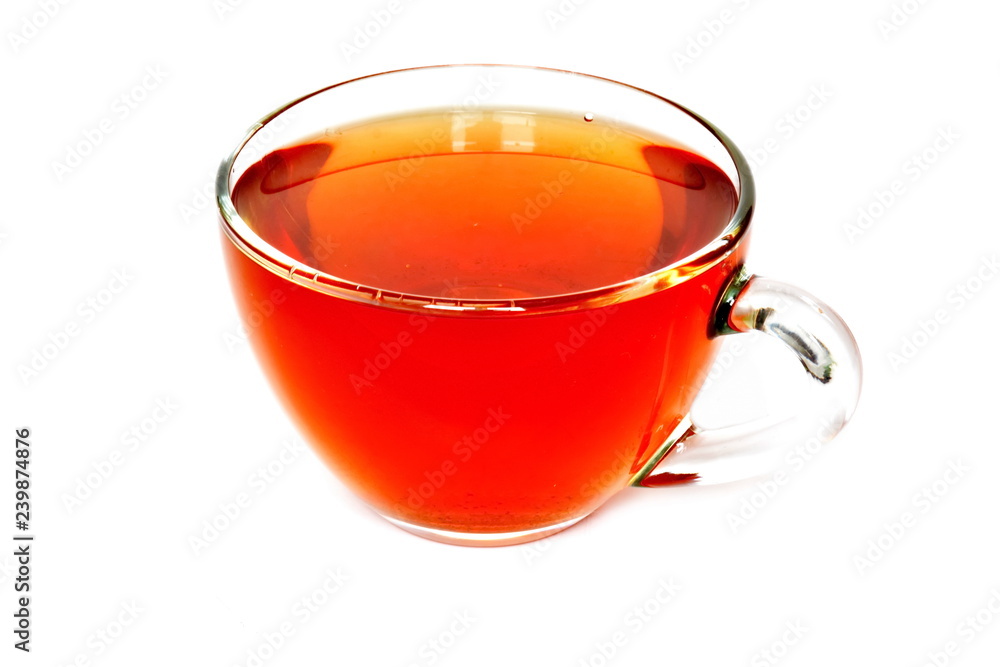 Glass cup of golden tea on white background. Isolated Glass cup of golden tea on white background. Isolated