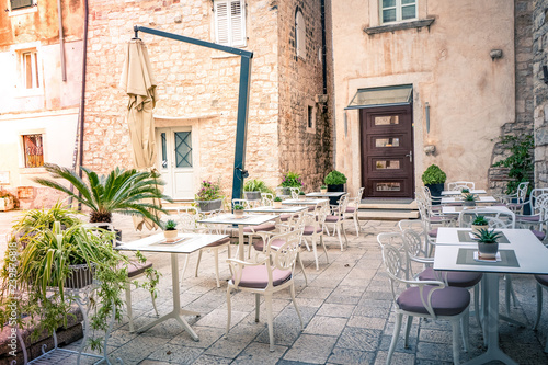 Fototapeta Naklejka Na Ścianę i Meble -  Mediterranean cafe terrace on an old street in ancient town