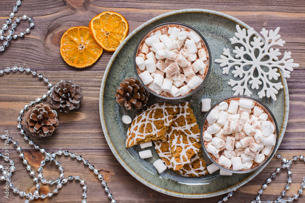 Dried mandarin slices, hot cocoa with marshmallows and christmas cookies on the table in Christmas decorations. Top view Dried mandarin slices, hot cocoa with marshmallows and christmas cookies on the table in Christmas decorations. Top view