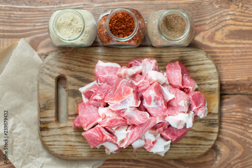 Fresh raw pork sliced on wooden background.