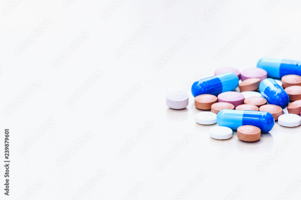 Medications of various colors on a light background. Space for text.