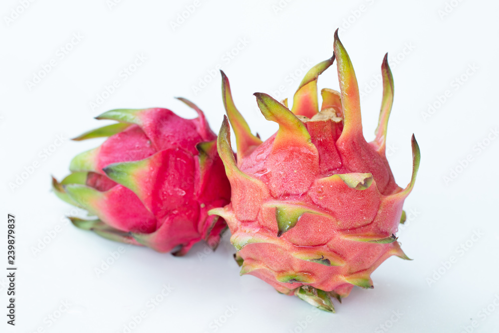 Fresh pitahaya fruit on white background or ripe dragon fruit red color with copy-space design for drinks package design, healthy article picture and plantation guide book design Fresh pitahaya fruit on white background or ripe dragon fruit red color with copy-space design for drinks package design, healthy article picture and plantation guide book design