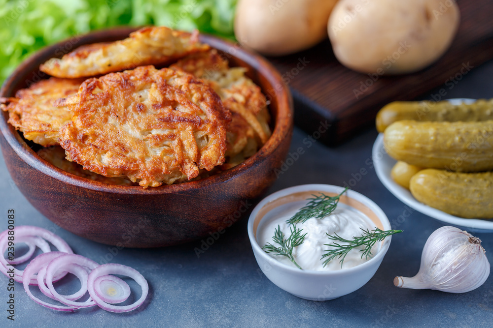 Draniki - potato fritters. potato pancakes lie on a plate. The national dish of Belarus, Ukraine, Russia. Draniki - potato fritters. potato pancakes lie on a plate. The national dish of Belarus, Ukraine, Russia.