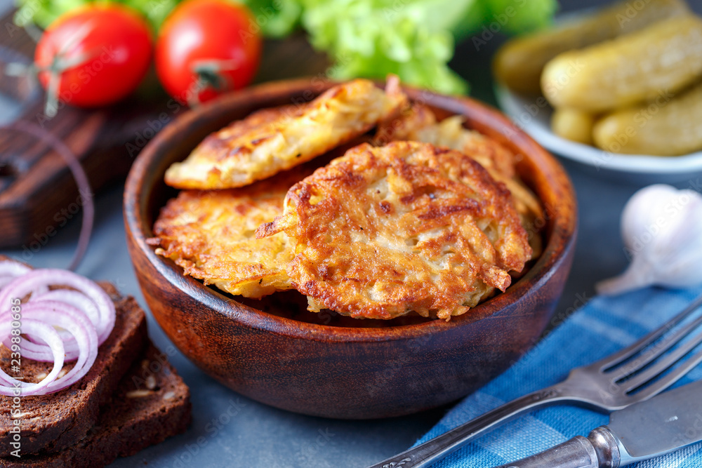 Draniki - potato fritters. potato pancakes lie on a plate. The national dish of Belarus, Ukraine, Russia. Draniki - potato fritters. potato pancakes lie on a plate. The national dish of Belarus, Ukraine, Russia.