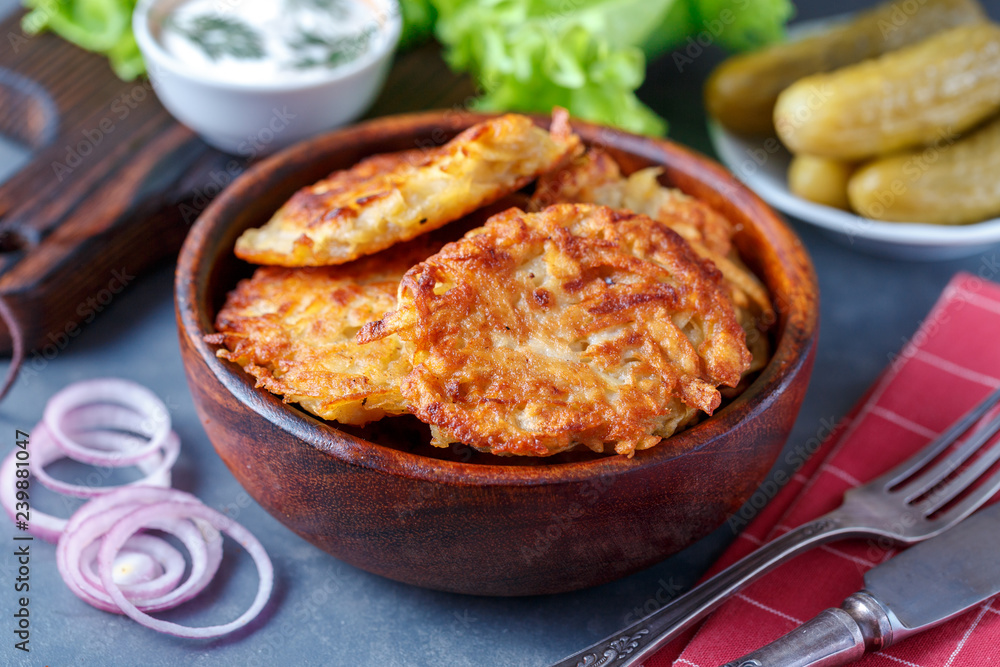 Draniki - potato fritters. potato pancakes lie on a plate. The national dish of Belarus, Ukraine, Russia. Draniki - potato fritters. potato pancakes lie on a plate. The national dish of Belarus, Ukraine, Russia.