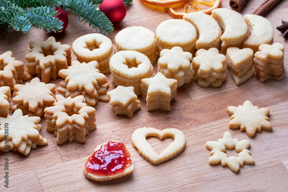 Filling Linzer Christmas cookies with strawberry marmalade